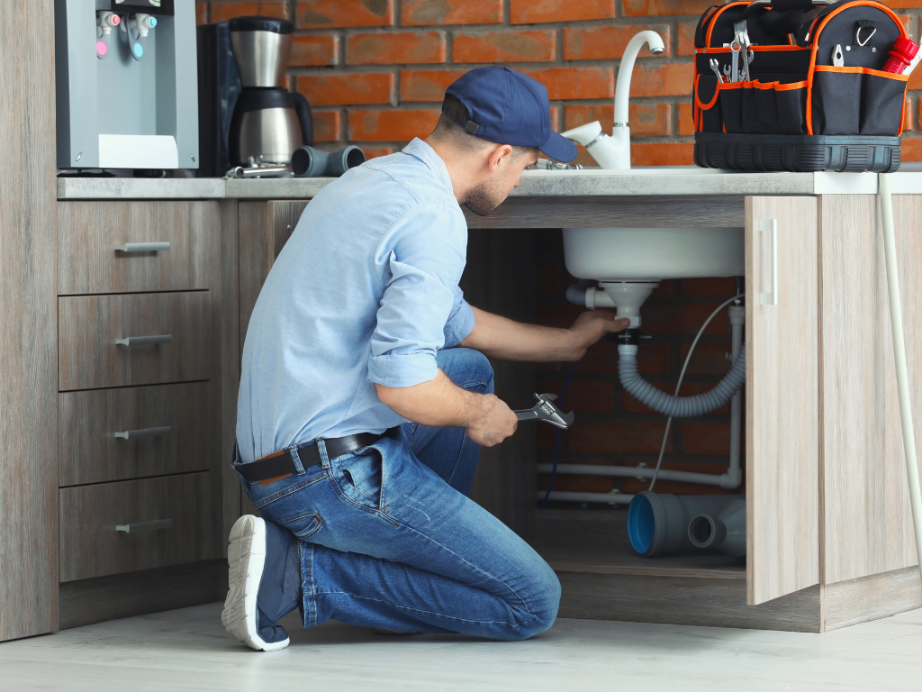 plumber fixing sink